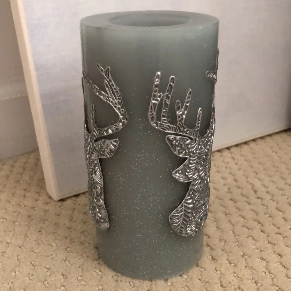 Pier 1 candle deer motif. Unused. Grey, blue, silver. 3” wide, 6” high
